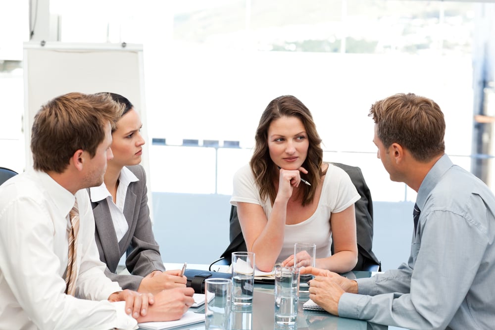 Charismatic businesswoman at a table with her team during a meeting